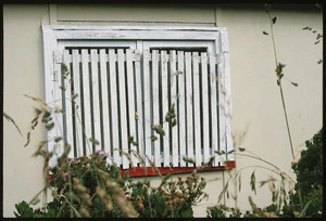 Slatted window shutters on a bach at Oaro