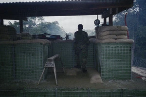 Standing guard at the main gateway, Suai Military Camp, East Timor - Photograph taken by Kyle Harbour