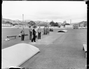 Removing covers from the cricket pitch at the Basin Reserve, Wellington
