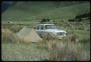 Austin A40 car parked beside a small tent, Wairarapa