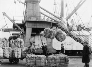 Wellington wharf workers moving bales of export sheep skins