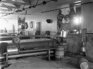 Inside a cheese factory in Kaponga, showing three workers and equipment
