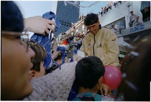 Russell Coutts signing autographs during the America's Cup parade, Willis Street, Wellington - Photograph taken by Melanie Burford