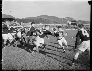 A Wellington player tackling an Auckland player during a rugby match