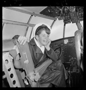 Schoolboy sitting in captain's seat aboard Tasman Empire Airways Ltd Solent Awatere