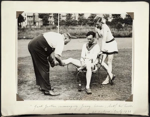 Photograph of Jerry Cornes being massaged by Jack Gerken with Jack Lovelock looking on