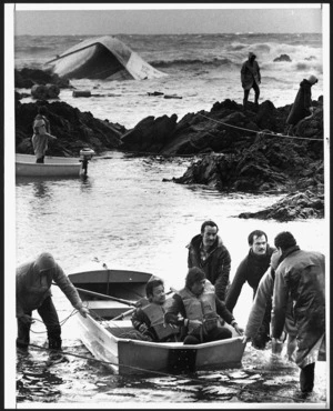 Crew of wrecked Taiwanese fishing boat the Yung Pen are brought ashore by residents and police at Owhiro Bay, Wellington - Photograph taken by John Nicholson