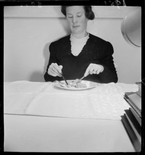 Woman showing the correct way to hold a knife and fork