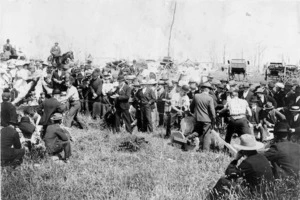 A crowd watching a wood sawing competition, including Dave Biggs and W Bigham, Kaponga