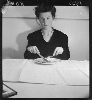 Woman showing the correct way to hold a knife and fork