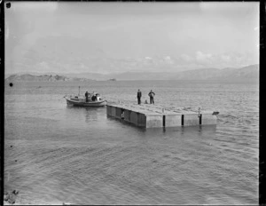 Section of the flying boat pontoon being towed by pilot boat Tuna from Seaview to Evans Bay, Wellington