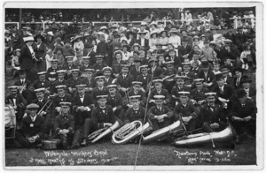 Waterside workers brass band at a mass meeting of strikers during the 1913 strike, Newtown Park, Wellington