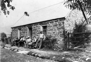 Men outside The Cottage, Benmore