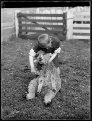 Boy posing as a sheep shearer