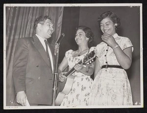 Johnny Cooper on stage with two unidentified contestants