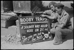 Sign warning soldiers about booby traps, on a road near Sora, Italy, during World War II - Photograph taken by George Kaye
