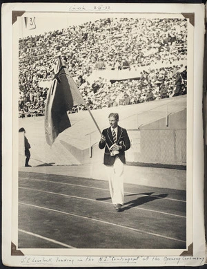 Photograph of Jack Lovelock carrying the New Zealand flag at the opening ceremony of the International Student Games