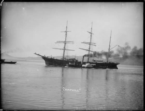 Sailing ship Camphill, in Otago Harbour. Towed by tugboats, one in front, partially obscured, and one in foreground, alongside the Camphill.