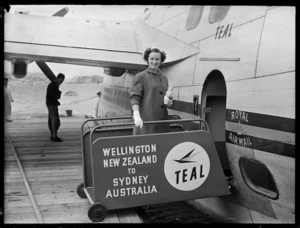 Air hostess Miss J Stanich by the TEAL Solent flying boat Awatere, Evans Bay, Wellington