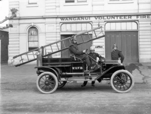 Fire engine and firemen outside the Wanganui Volunteer Fire Brigade Building