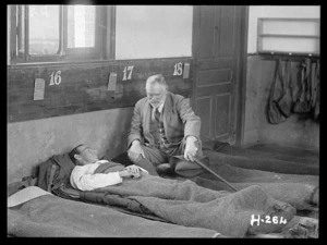 Sir Thomas MacKenzie at a soldier's bedside during World War I, France