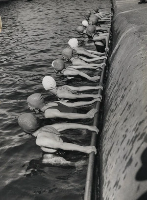 Swimmers during learn to swim week, at a suburban swimming pool, probably Wellington region - Photograph taken by William Hall Raine