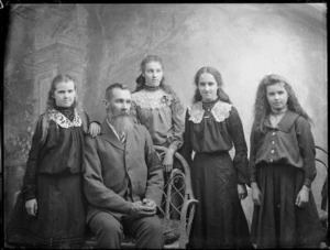 Studio portrait of man with four girls