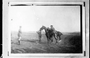A World War I officer mounting a horse