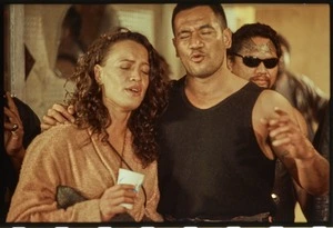 Production still showing Beth and Jake Heke singing at a party