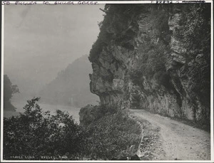 A horse-drawn coach travelling along the Buller Gorge Road at Hawkes Crag