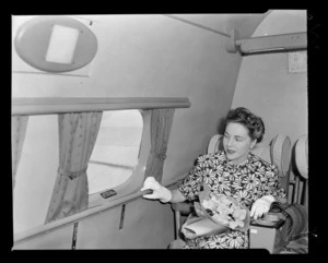 Mary Wootton (Miss New Zealand) inside a Tasman Empire Airways Ltd aeroplane