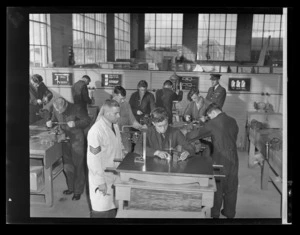 Technical Training School, F/O P Anker and Sgt R E [Sherer?], instructing engine mechanics in basic fitting, Hobsonville, Auckland