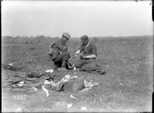 A World War I New Zealand soldier bandages a German soldier in Grevillers, France