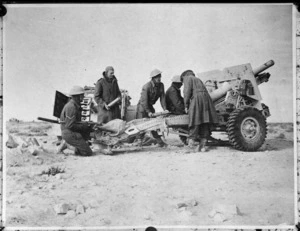 World War II soldiers from New Zealand Artillery, in Libya, shelling enemy positions near Sidi Resegh with a 25 pounder gun