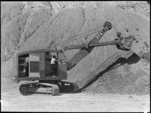 Earthmoving machine at work during road construction, location unknown