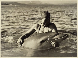 Woman with Opo the dolphin, at Opononi - Photograph taken by Eric Lee-Johnson