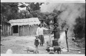 Maori village scene, with women cooking over an open fire and ponga whare; location unidentified