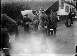 New Zealand soldiers buying vegetables in a French village