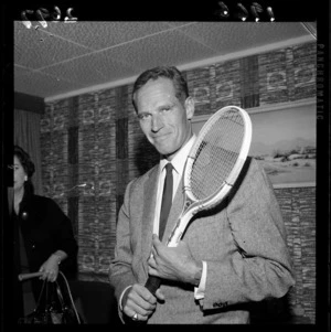 Charlton Heston holding a tennis racket