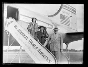 Mr and Mrs Barker with secretary Miss R Bourke on the gangway of Pan American World Airways Clipper Australia NC88952