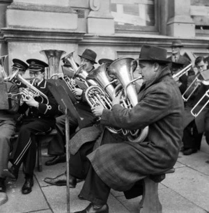 Brass band on a Wellington wharf, welcoming back New Zealand soldiers from overseas