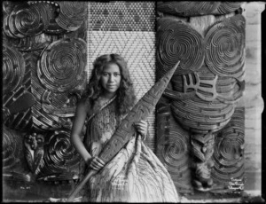 Unidentified young Maori woman holding a hoe