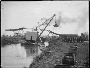 Dredge in use in Kaitaia, possibly on the Awanui River, during a drainage project on the the Kaitaia swamp
