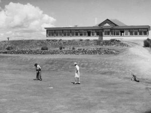 Two golfers on the 18th green, Paraparaumu Golf Course