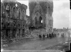 New Zealand soldiers passing the ruins of the Cloth Hall in Ypres, Belgium