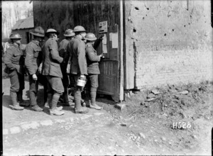 World War I New Zealand soldiers reading the daily news sheet, France
