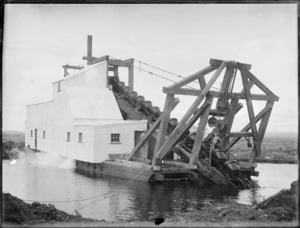 Dredge in use during a drainage project on the the Kaitaia swamp, possibly on the Awanui River