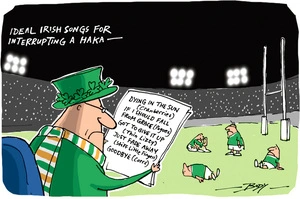 An Irish rugby fan reads a list of songs by Irish bands to find "songs for interrupting a haka" as Ireland team members sit dejected on the field