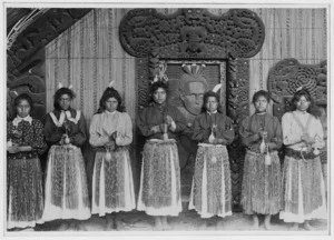Unidentified women with poi outside the Te Rauru meeting house, Whakarewarewa, Rotorua