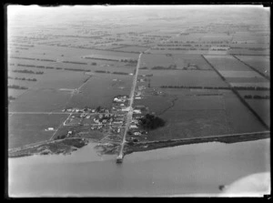 The settlement of Ruawai surrounded with farmland, with Ruawai Wharf Road (State Highway 12) and the Wairoa River in foreground, Kaipara Harbour, Northland Region